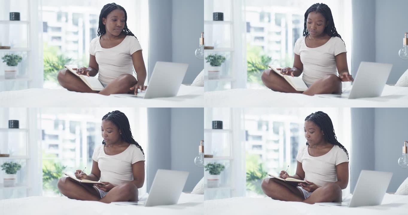 4k视频片段，一名妇女坐在笔记本电脑上做笔记