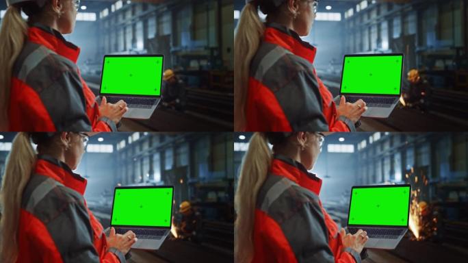 专业重工业工程师使用带有绿屏模拟显示的笔记本电脑。在金属制造仓库工作的女性工业专家，背景是火花。