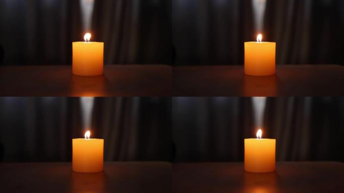 桌子上的单个发光蜡烛