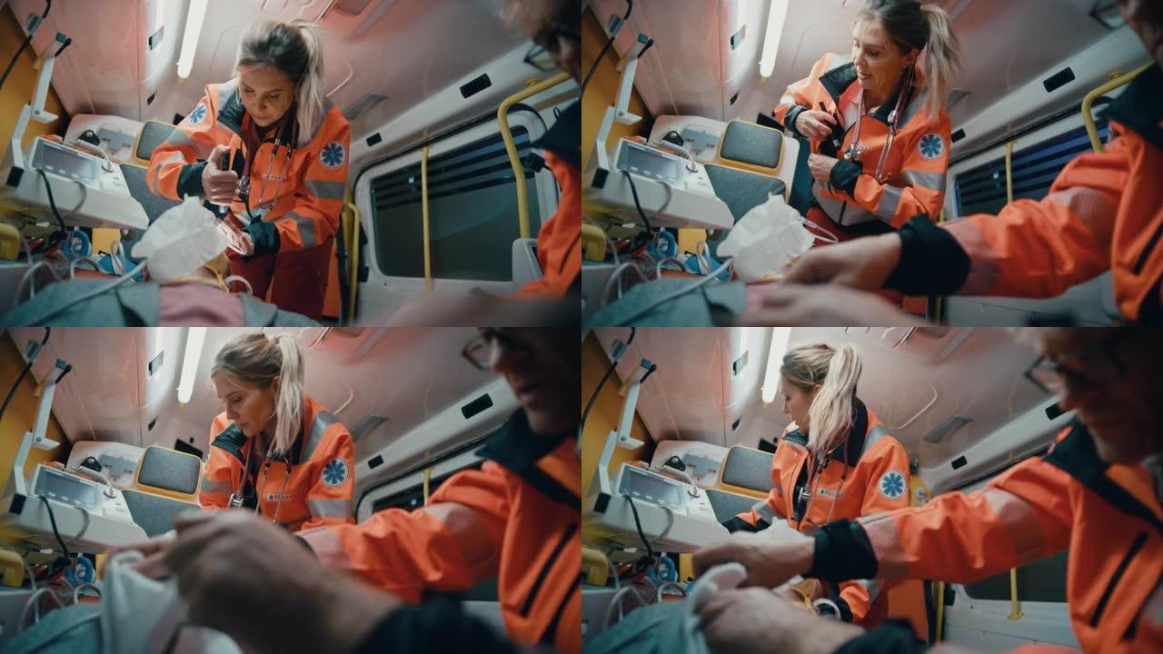 女性和男性EMS护理人员提供医疗帮助受伤的病人在去医疗保健医院的路上。急救助理在救护车中用手电筒检查