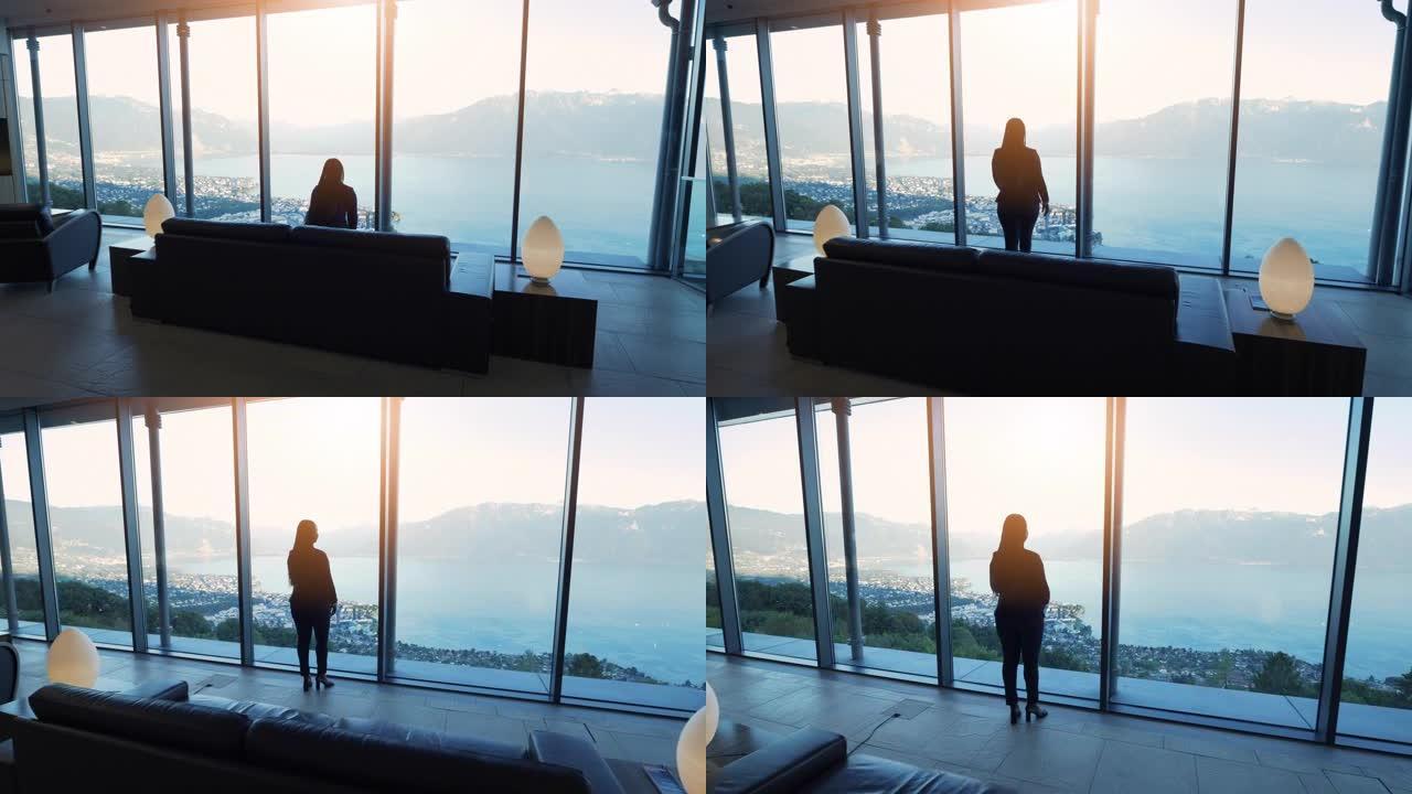 现代未来建筑内的女性商人俯瞰湖泊城市全景窗口视图