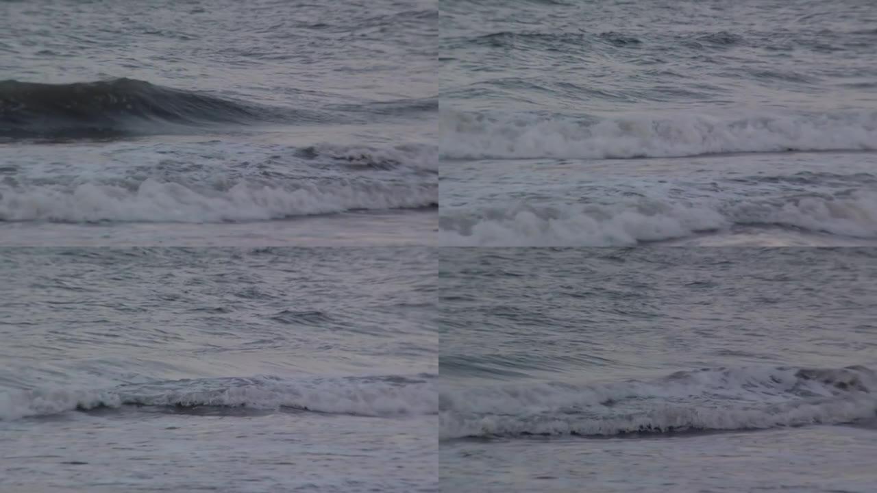 阿根廷3月普拉塔，日落时分，海浪在沙滩上撞击。