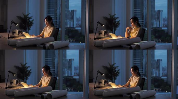 亚洲建筑师女人晚上在办公室工作到很晚，工作过度