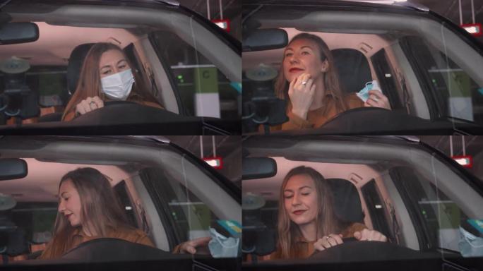 封锁后的正常生活。美丽的年轻微笑的女人上车，摘下口罩，看着镜子开车