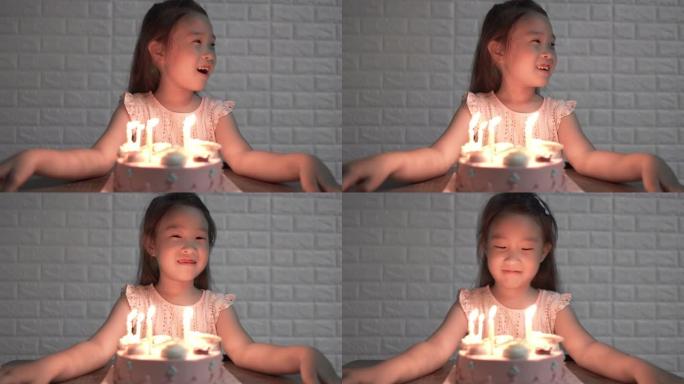 女孩在生日那天在生日蛋糕上吹蜡烛