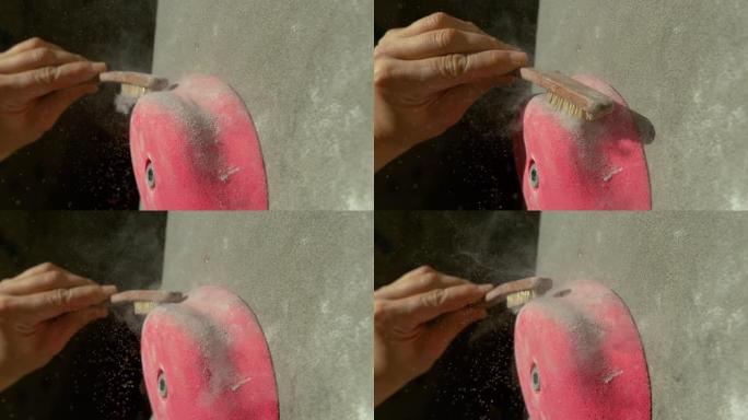宏观: 无法识别的攀岩者用牢固的刷子清理了粉红色的压接