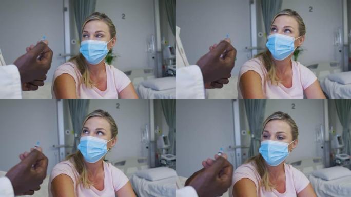 戴口罩的高加索女患者坐在病床上等待注射