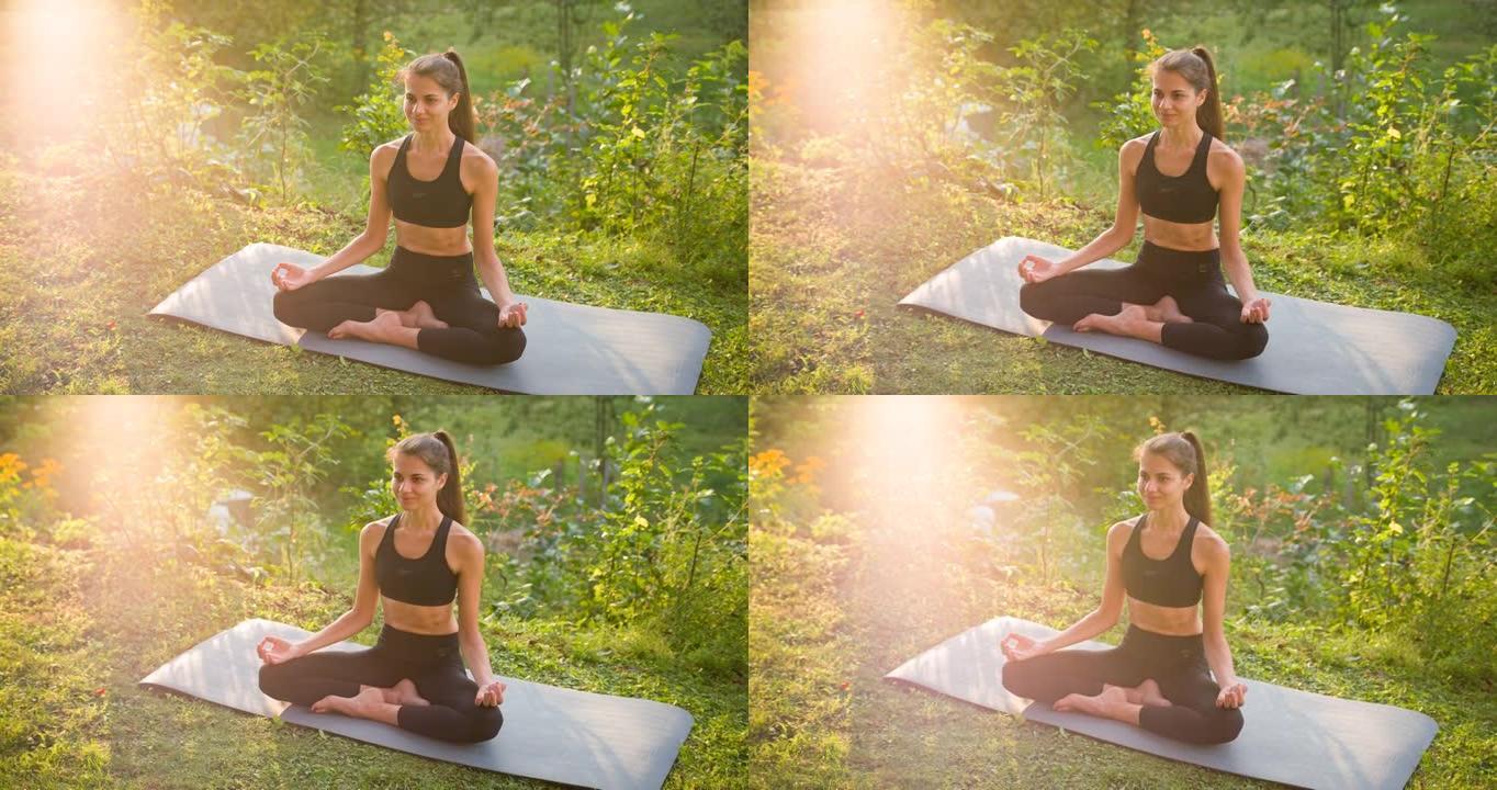 年轻女子身体活跃，日落时在后院户外练习瑜伽