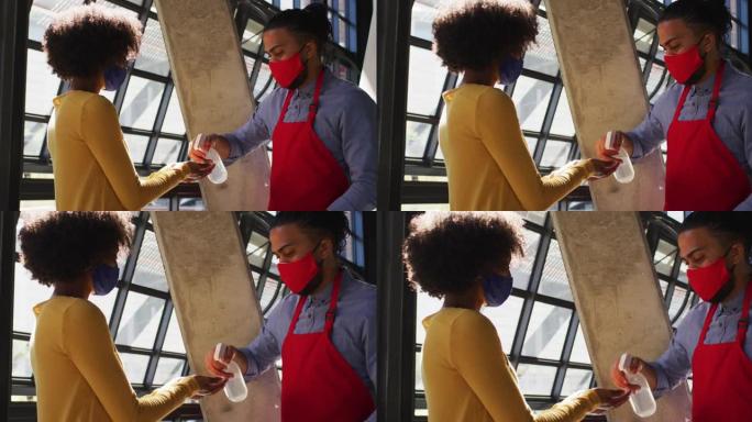 混合种族的男服务员戴着面罩为女同事测体温
