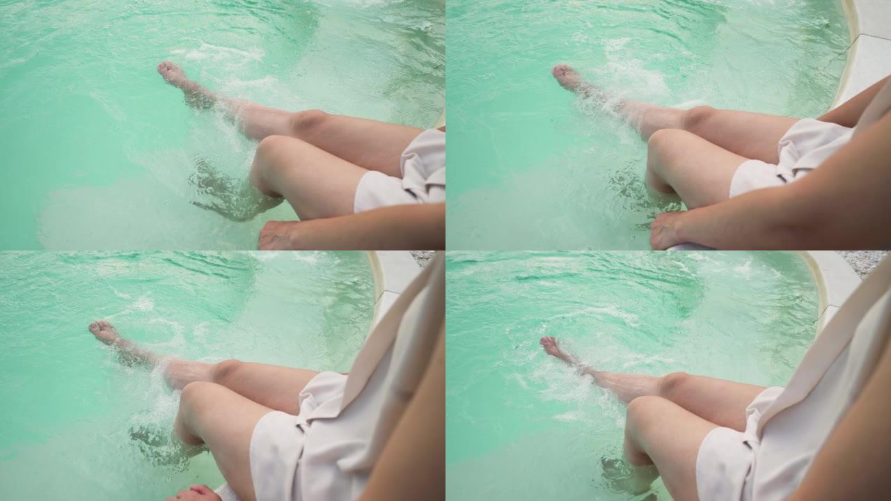 女人在气泡喷射空气游泳池放松双腿，水疗