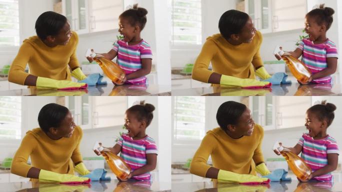 非裔美国母亲和女儿清洁台面并在厨房大笑