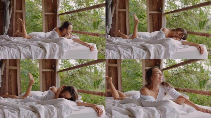快乐的女人躺在酒店度假胜地的床上，享受享受热带丛林舒适放松的假期