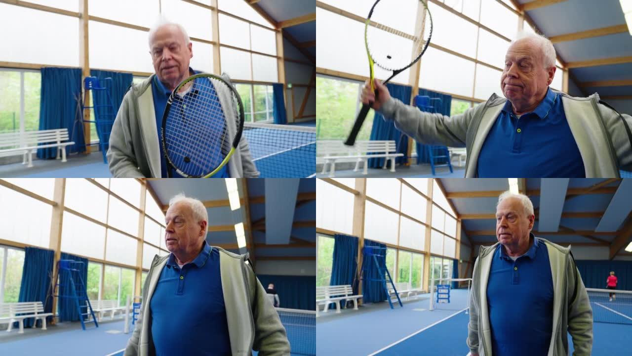 穿着运动服的活跃老人在室内球场打网球