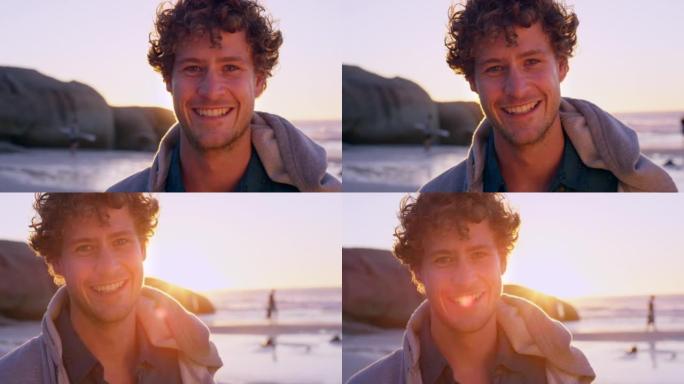 一个英俊的年轻人在日落时独自站在海滩上的4k视频片段