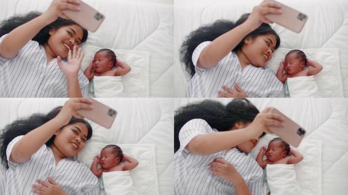 新生婴儿和新手妈妈用智能手机相机微笑着自拍