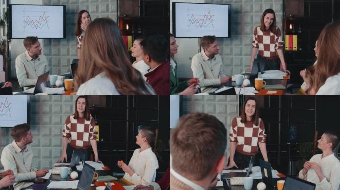 成功自信的女性领导者，公司老板微笑着，带领团队会议与年轻同事慢动作交谈。