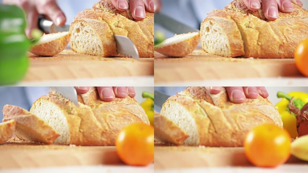 4k视频片段，一个人切成一条新鲜的面包