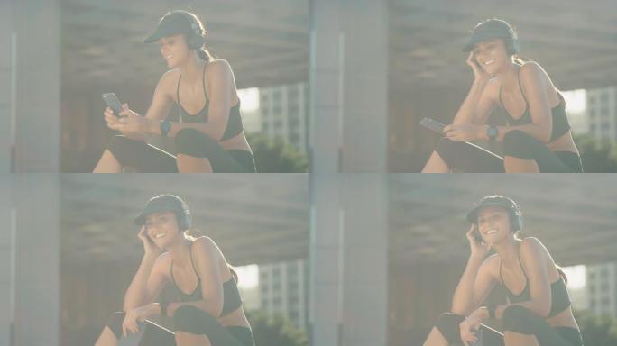 4k视频片段，一名运动的年轻女子坐在外面听音乐