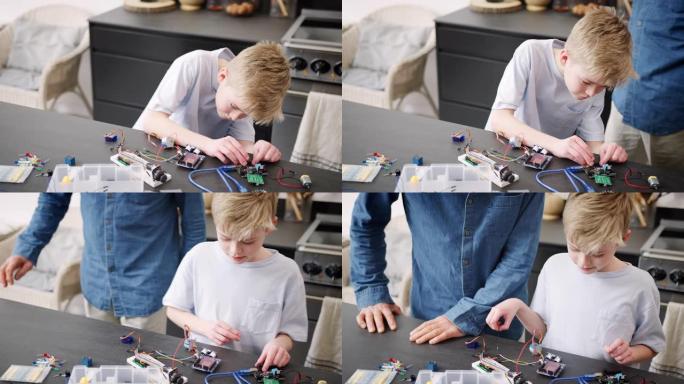 孙子与祖父组装电子元件在家中一起建造机器人