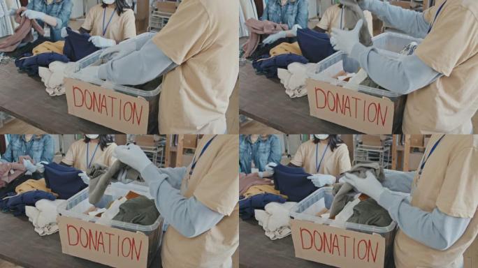 志愿者用衣服整理捐赠容器