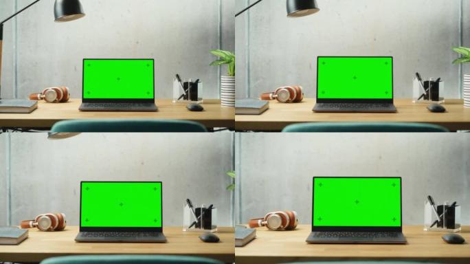 笔记本电脑，模拟绿屏显示站在桌子上。高效简约的现代办公空间设计，保证和谐与生产力。模拟色度键监视器