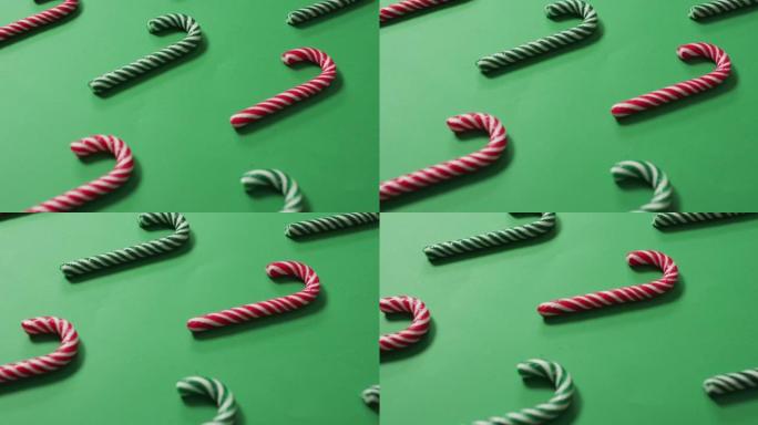 绿色背景上的红色和绿色条纹糖果棒