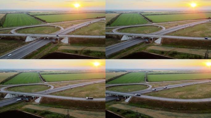 日落时分美丽农田多车道公路和道路交叉口航拍视频