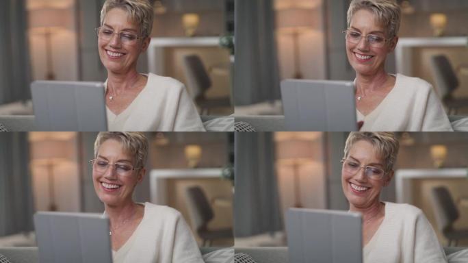 一名高级女性坐在家里使用数字平板电脑的4k视频片段