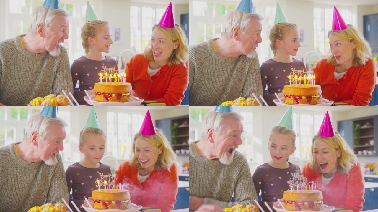 祖父母和孙女一起庆祝在家里的生日蛋糕上吹蜡烛