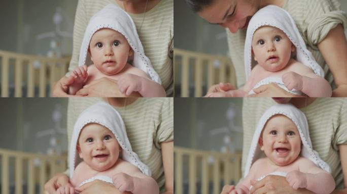 一个可爱的棕色眼睛的快乐新生婴儿的真实特写镜头正看着镜头