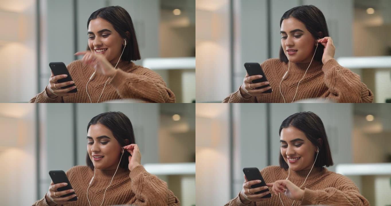 4k视频片段，一名年轻女子在手机上听音乐时戴着耳机