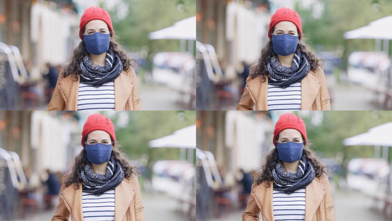 城市人行道上戴防护面罩的女性