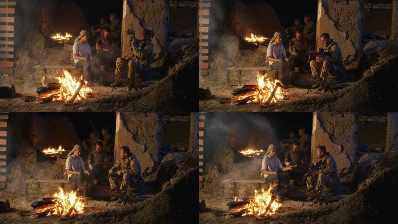 士兵和青少年在篝火旁休息