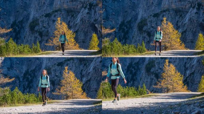 年轻的健身女子在徒步旅行时保持健康，在山上呼吸新鲜空气