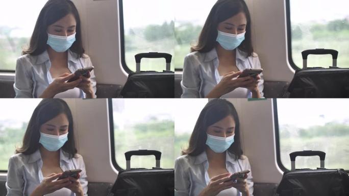 使用智能手机在捷运中佩戴带防护面罩的亚洲旅行者
