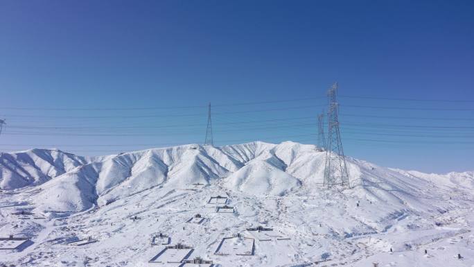 航拍雪后嘉峪关文殊山山坡坟墓