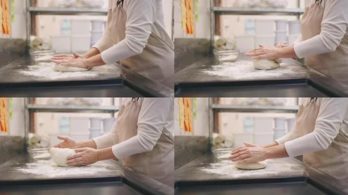 一个无法辨认的面包师在面包店里塑造面团的4k视频片段