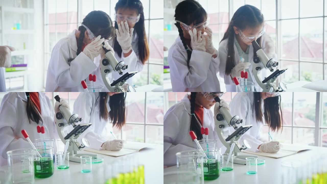 在生物学和科学课上使用显微镜与导师的特写小学生。STEM教育。