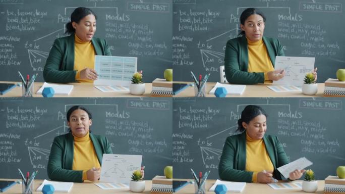 非裔美国女士在教室里用粉笔板在室内教授英语在线讲座