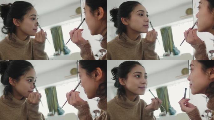 可爱的亚洲女孩在镜子前化妆