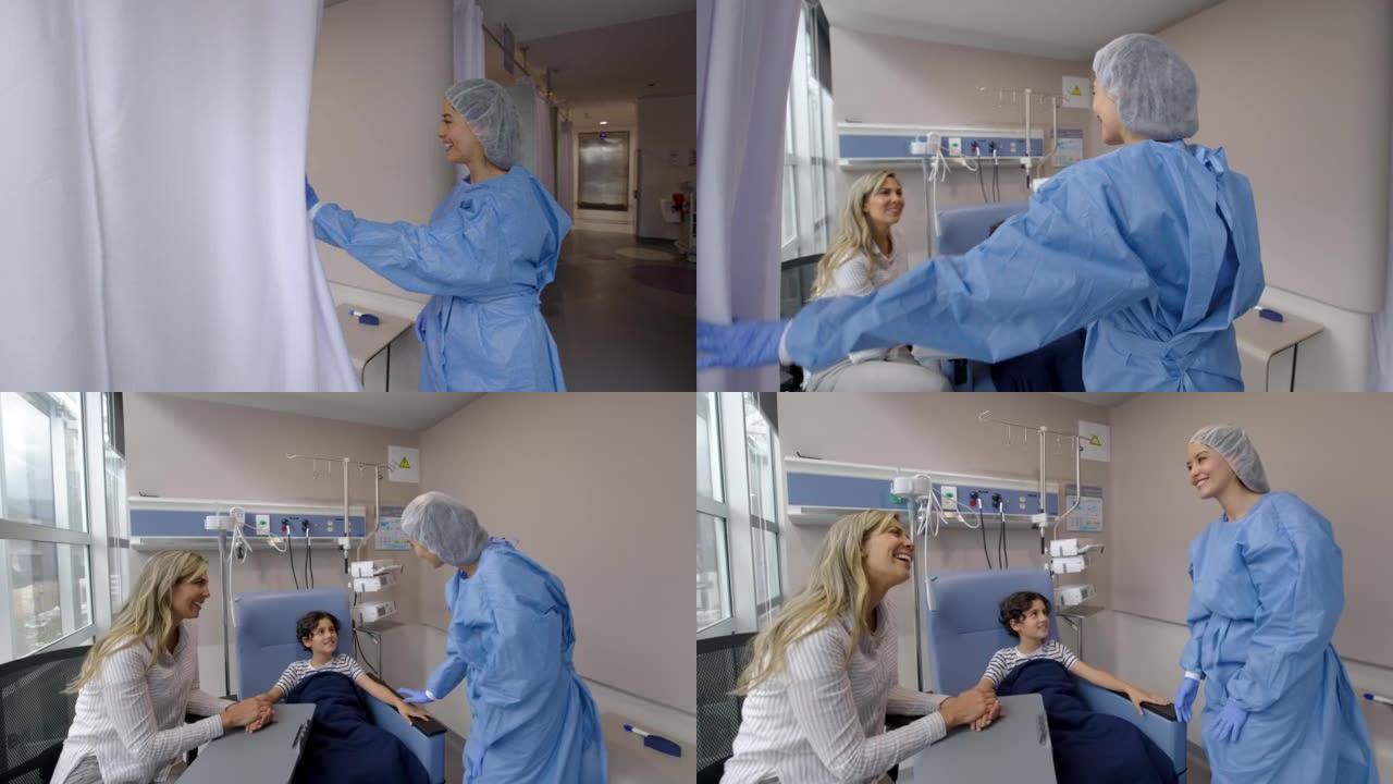 女护士走向小男孩和妈妈，准备在医院接受化疗