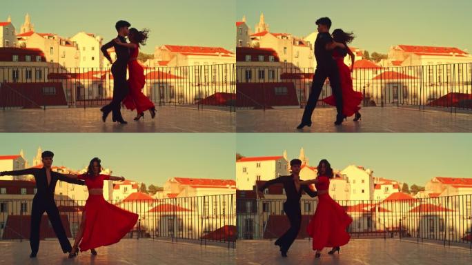 美丽的夫妇在城市外跳拉丁舞，背景是老城区。在古老的文化底蕴丰富的旅游地点，由两名专业舞者在日落时进行