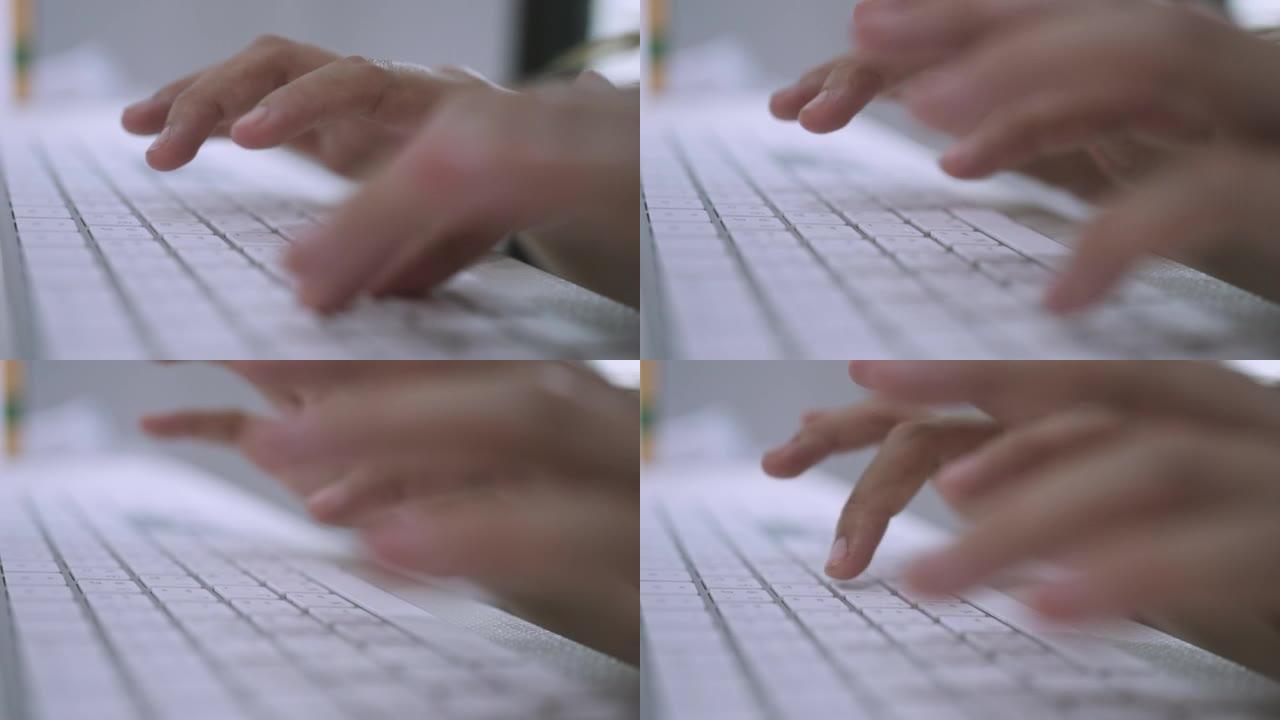 女人手在笔记本电脑键盘上打字