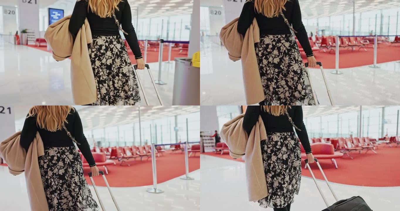 女人带着行李走过机场休息室
