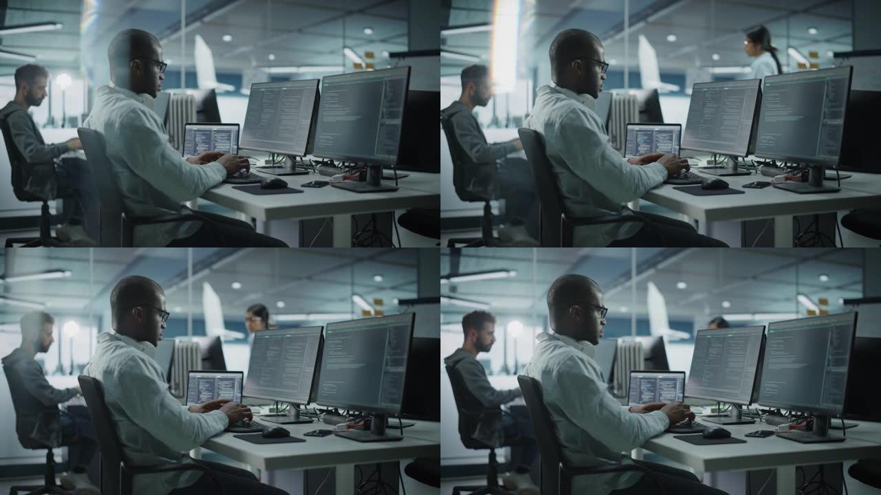 真实的办公室: 在台式计算机上工作的有动力的黑色IT程序员。男性网站，软件工程师开发应用程序，程序，