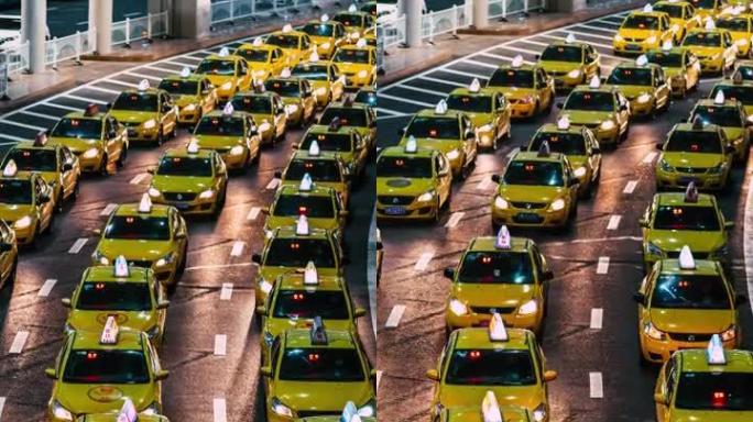 T/L TD夜间机场出口处繁忙的黄色出租车排队