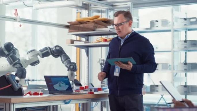 在机器人开发实验室: 未来的工程师和科学家致力于机器人手臂原型。职业企业家激励人们取得新成就