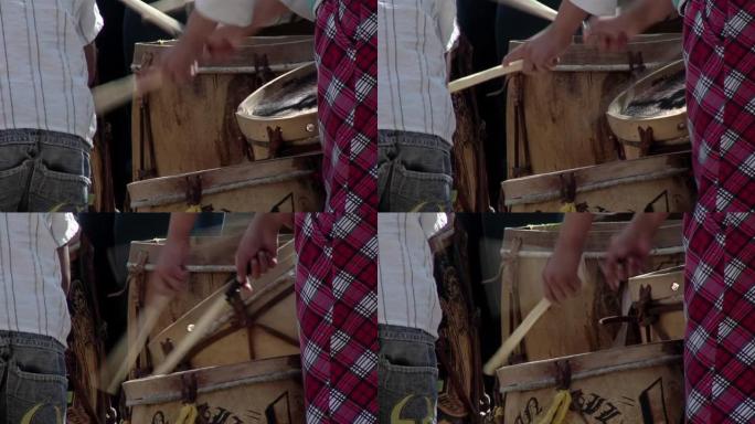 年轻人演奏典型的“Bombo Legüero”，这是阿根廷用木材和动物皮革制作的低音鼓。闭合。