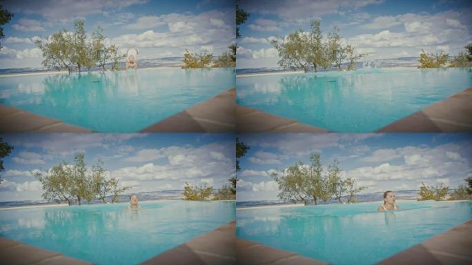 SLO MO DS女人在她田园诗般的度假别墅跳入游泳池
