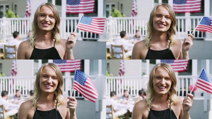 一个年轻女子在家里的派对上举着一面旗子的4k视频片段
